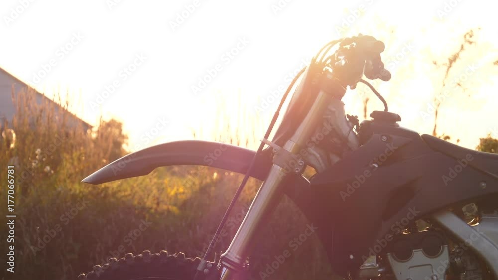 motocross dirtbike front end pan from bottom to top in sunset 4k