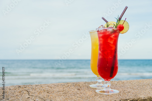 Iced cocktails drinking glass with beach and sea