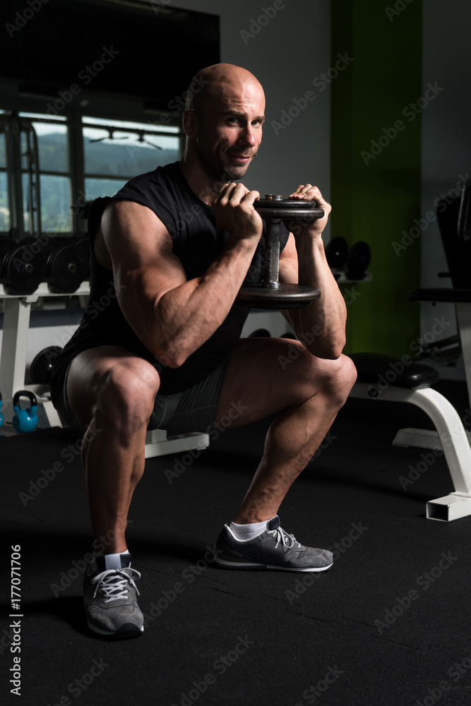 Man With Dumbbells Exercising Quadriceps And Glutes