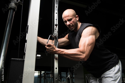 Bodybuilder Doing Heavy Exercise For Triceps With Cable