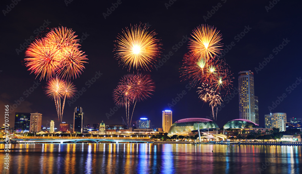 firework over cityscape of Singapore city at night
