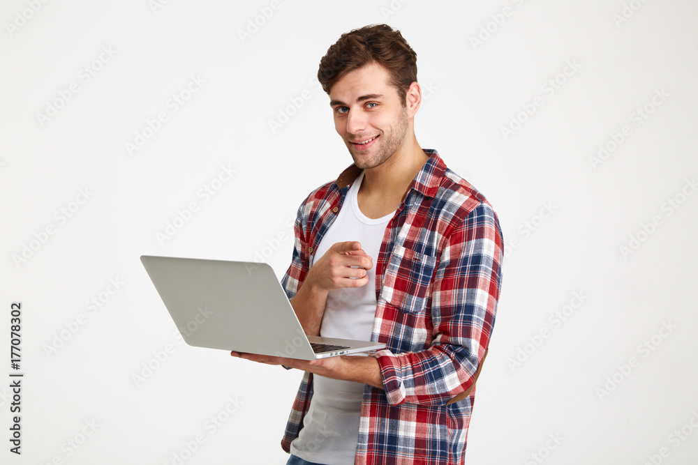Portrait of a confident young man holding laptop computer Portrait of a confident young man holding laptop computer