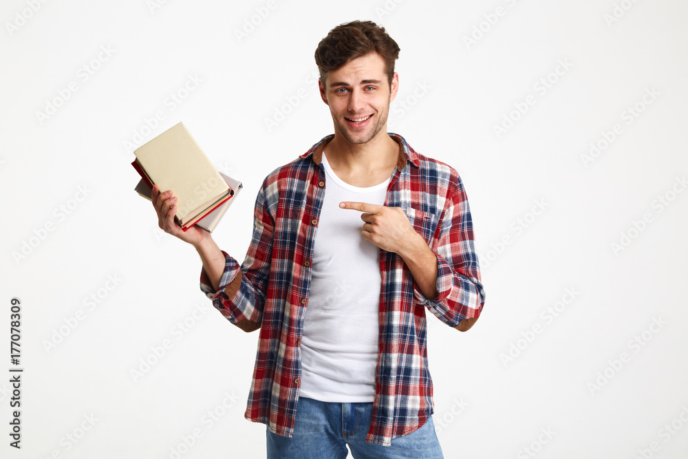 Portrait of a smiling male student holding books Portrait of a smiling male student holding books