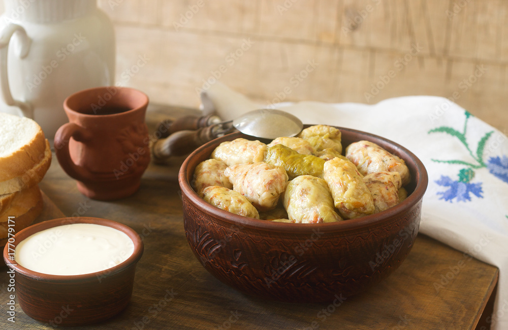 Cabbage rolls served with sour cream, bread and wine. Dolma, sarma, sarmale, golubtsy or golabki. Cabbage rolls served with sour cream, bread and wine. Dolma, sarma, sarmale, golubtsy or golabki.
