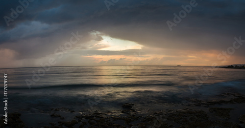 Panorama: the evening sky over the sea after a thunderstorm.