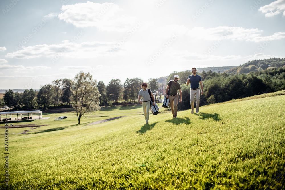 Golf player walking and carrying bag on course during summer game golfing Golf player walking and carrying bag on course during summer game golfing