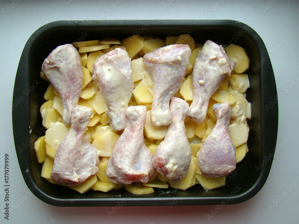 Raw chicken legs with potatoes Raw chicken legs with potatoes