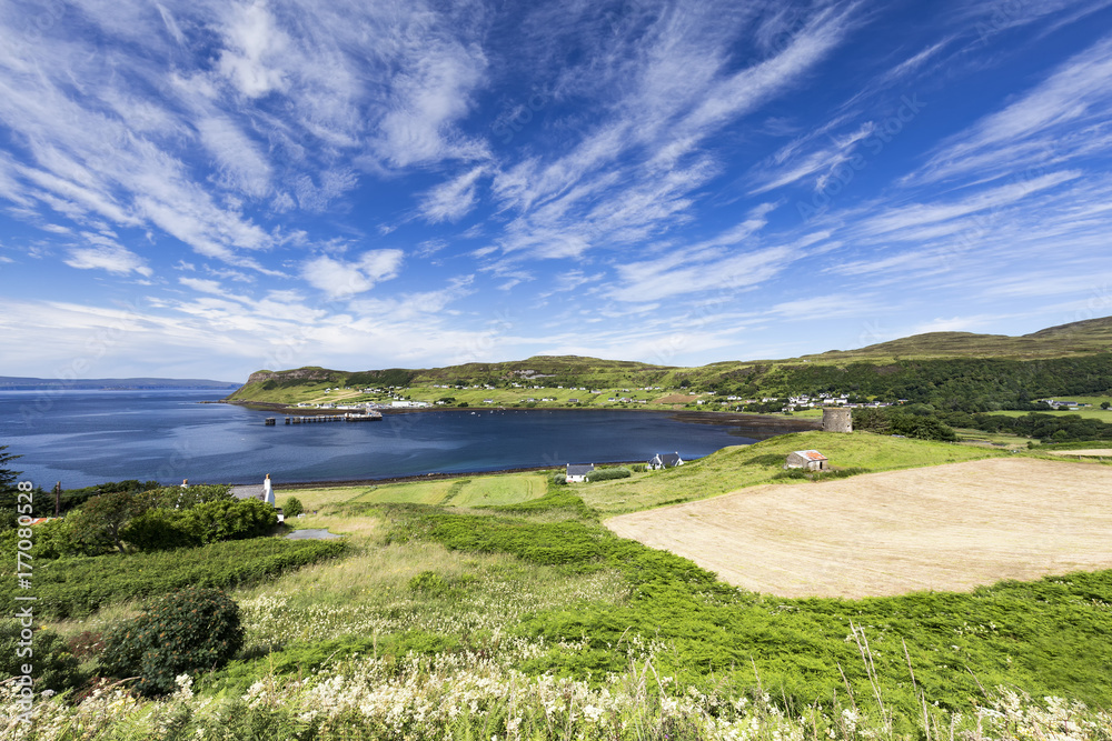 Fields and the port town of Uig on a summer morning on the Isle of Skye in Scotland.