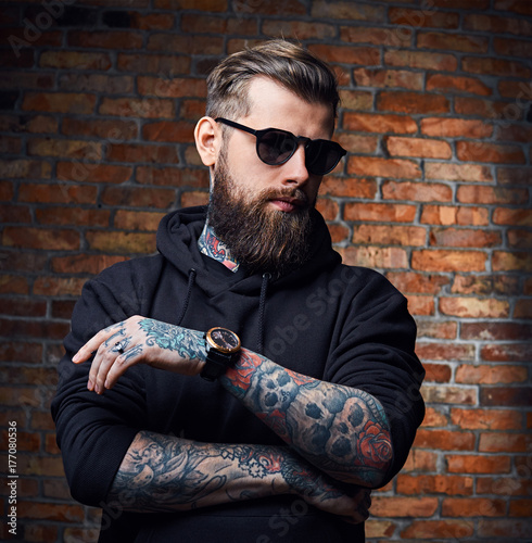 Tattooed bearded male in military jacket.