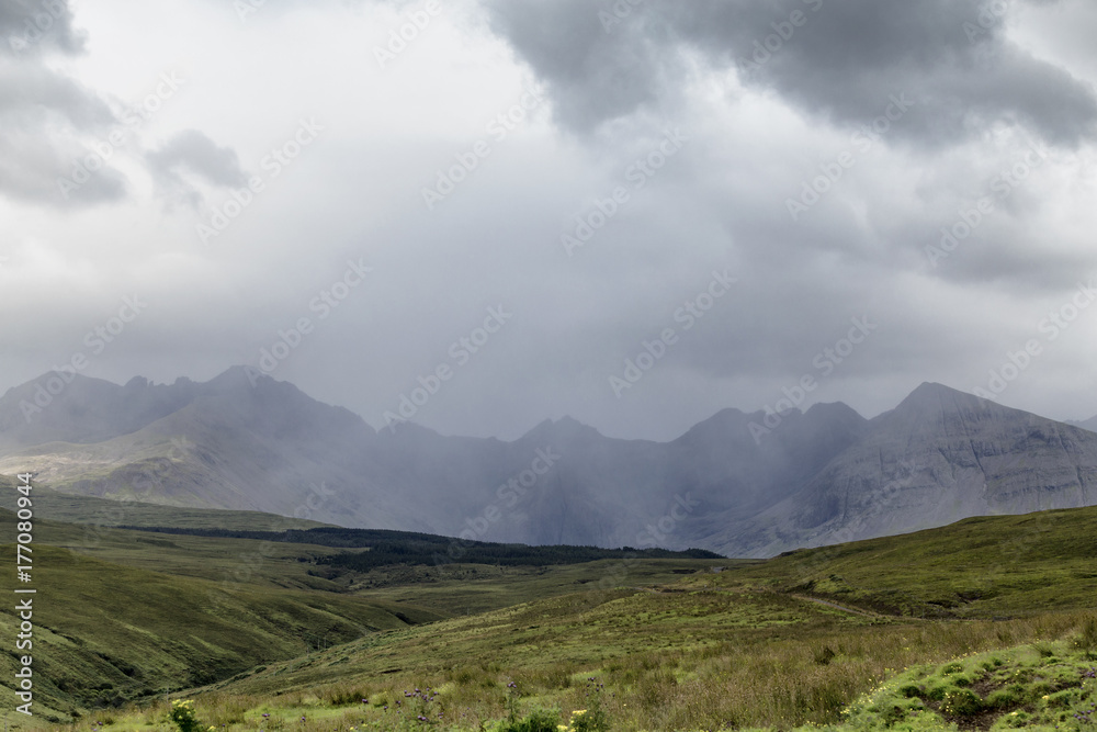A summer shower obscures Bruach na Frithe Mountain and the Fairy Pools on the Isle of Skye, in Scotland.