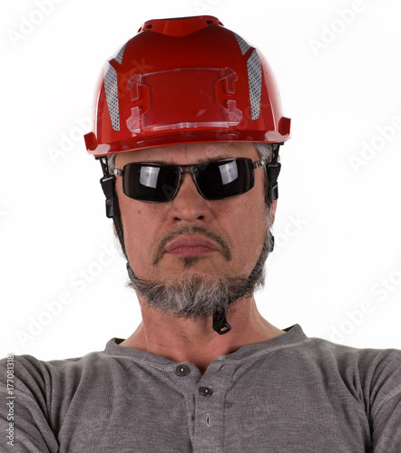 studio portrait of a worker in a construction helmet © serikbaib