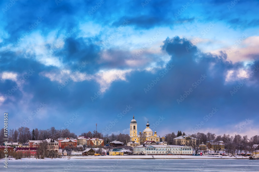 Russian Orthodox Church in the center of the city on the river bank under the winter cold sky in the clouds. Mishkin city, Volga river at winter, Welcome to Russia.