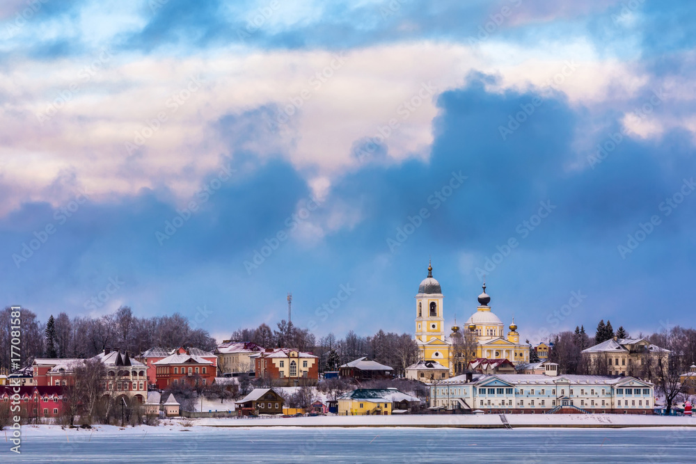 Russian Orthodox Church in the center of the city on the river bank under the winter cold sky in the clouds. Welcome to Russia. Mishkin city. Volga river at winter.