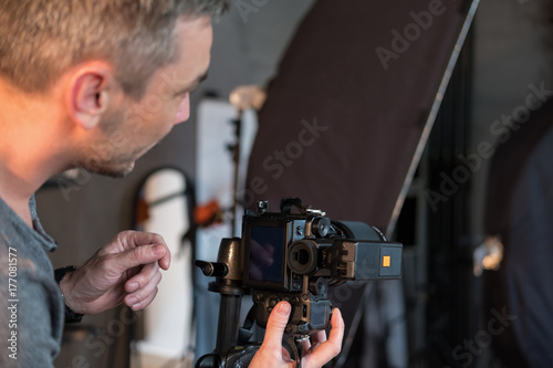closeup of the photographer in photo Studio, view from the side © warloka79
