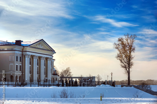 A beautiful building with columns on the banks of the Volga River next to the trees. Mansion on the waterfront of Uglich, Russia.