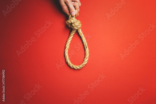 The man tightens the noose