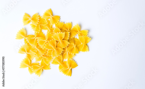 Uncooked bow tie pasta on white