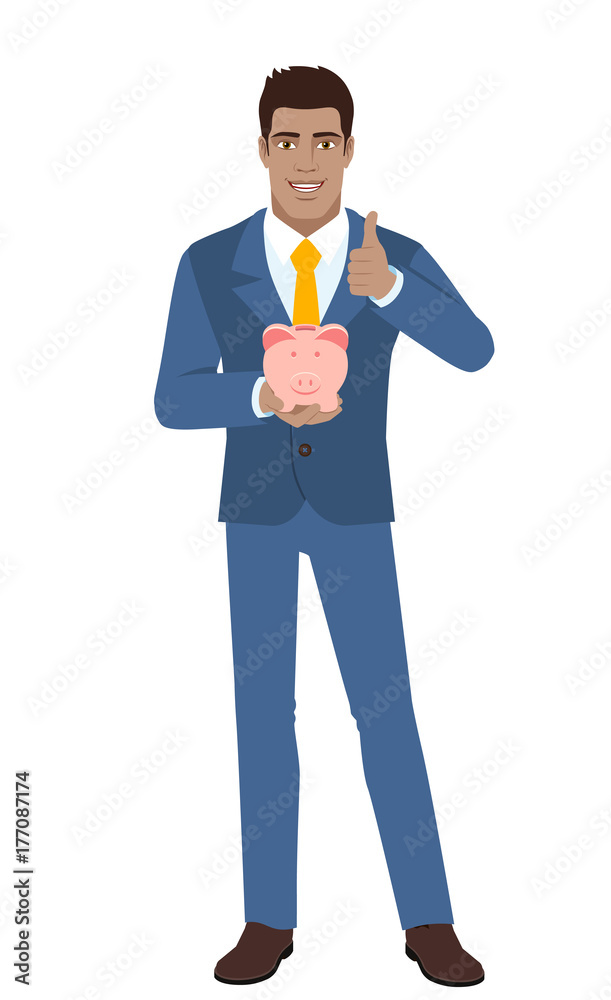 Businessman holding a piggy bank and showing thumb up Businessman holding a piggy bank and showing thumb up