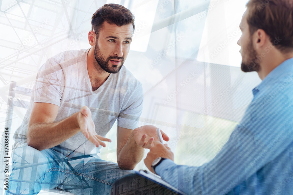 Fototapeta premium Handsome bearded man explaining his problem to psychiatrist