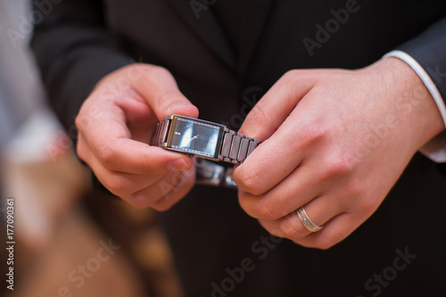 The man is holding hands for hours and has a ring in his hand