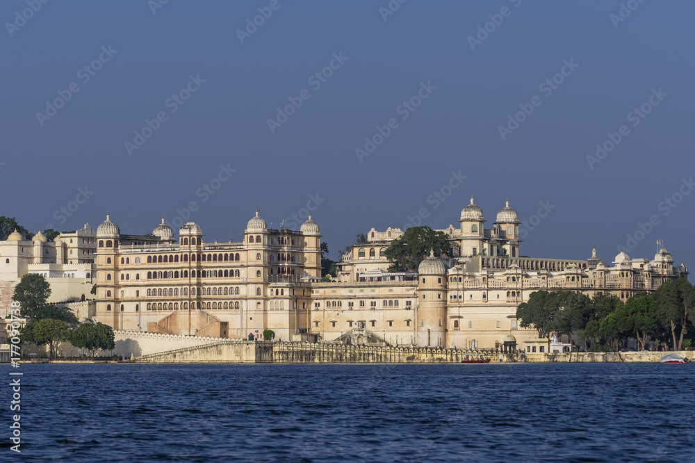 Stunning view of the ancient City Palace complex in Udaipur, India, from Lake Pichola