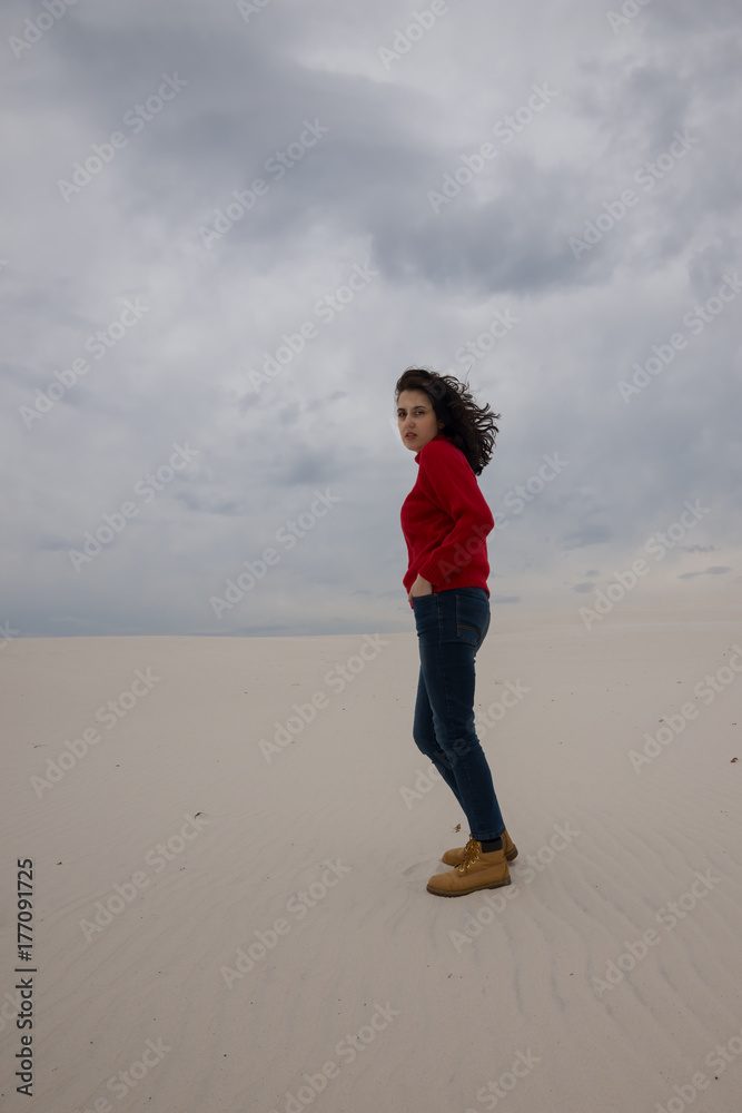 Expressive girl, with flying hair,  goes through the desert