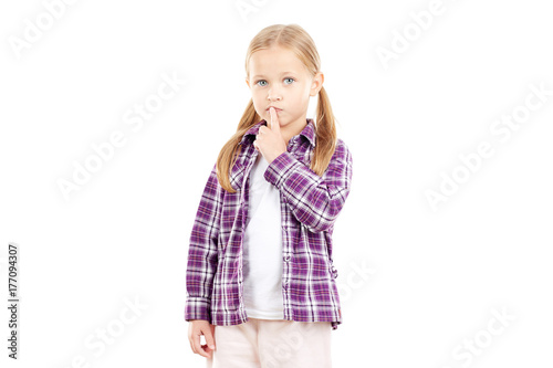 Portrait of little blonde girl in checked shirt on white background
