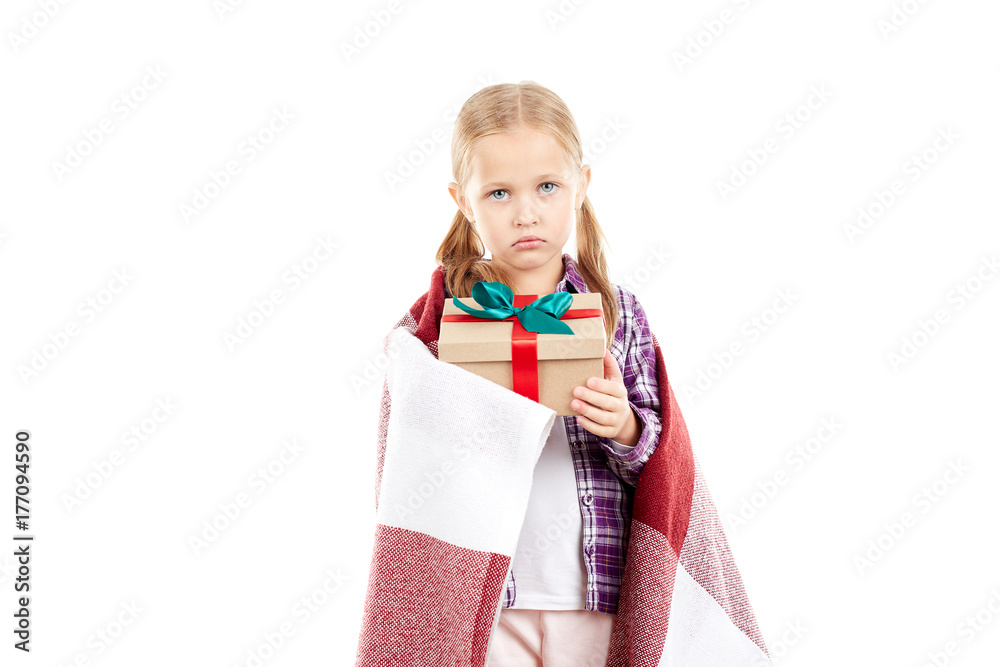 Studio portrait of little girl wrapped in blanket holding Christmas gift box Studio portrait of little girl wrapped in blanket holding Christmas gift box