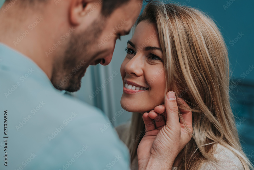 Romantic couple looking at each other and smiling.