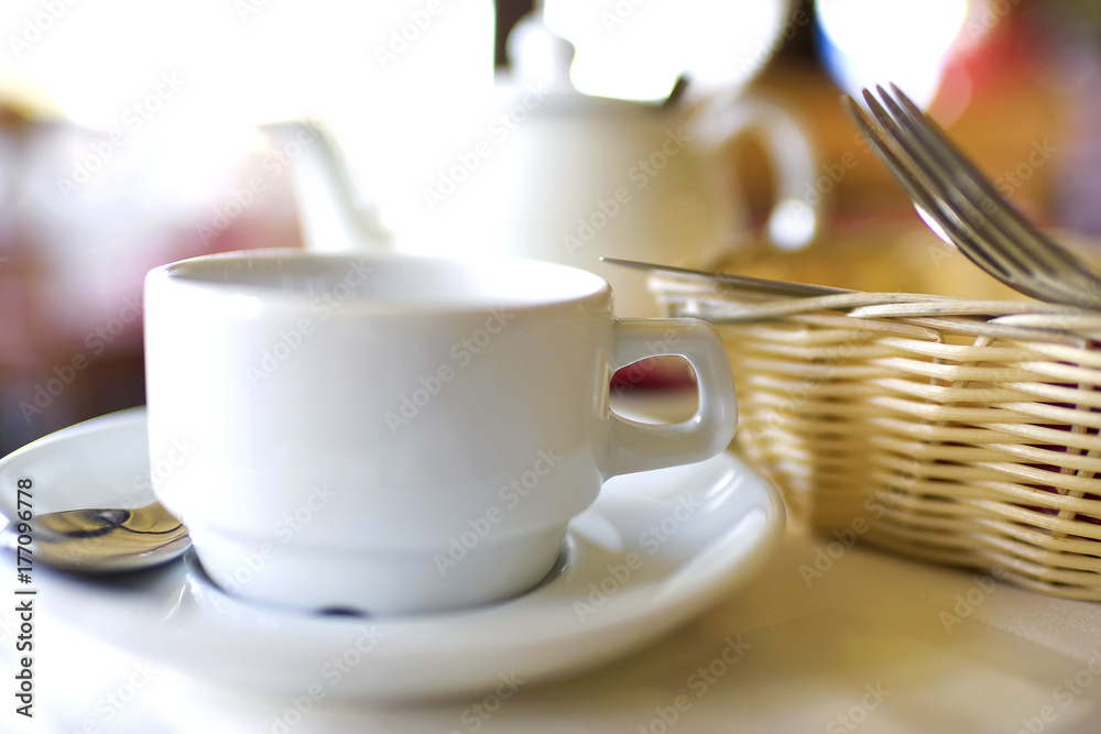 Kettle and a cup on the table Kettle and a cup on the table