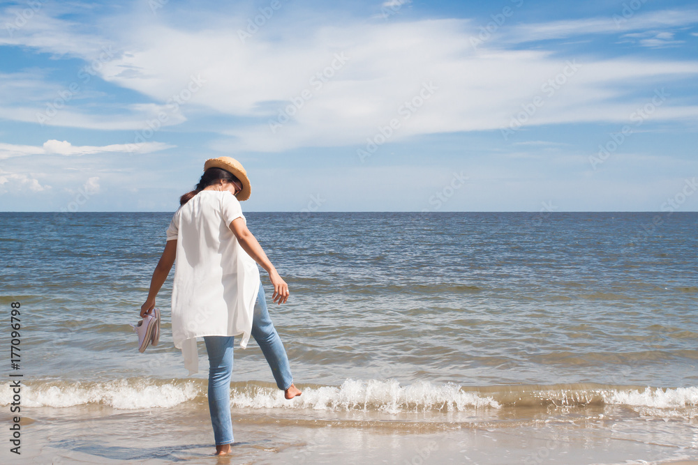 Beach vacation, Happy beautiful woman in jeans enjoying sunny day on beach, Freedom woman, Lifestyle concept Beach vacation, Happy beautiful woman in jeans enjoying sunny day on beach, Freedom woman, Lifestyle concept