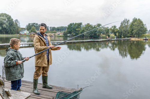 Father and son fishing on lake
