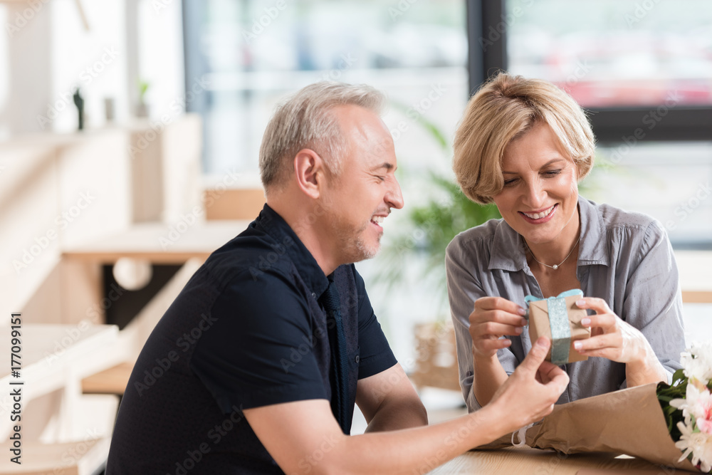 Man presenting gift to woman