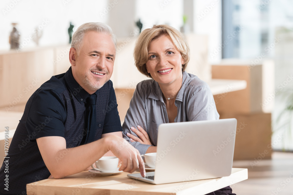 Couple sitting at table with laptop Couple sitting at table with laptop