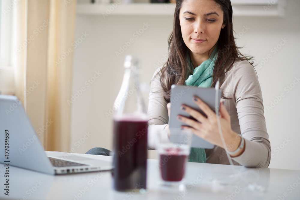 Businesswoman using tablet while sitting in home office Businesswoman using tablet while sitting in home office