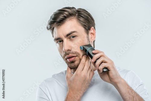 man using electric razor
