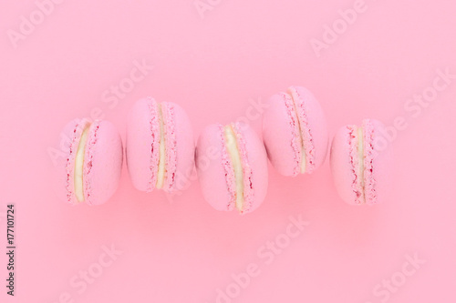 five pink macaroons homemade, on pink background, top view
