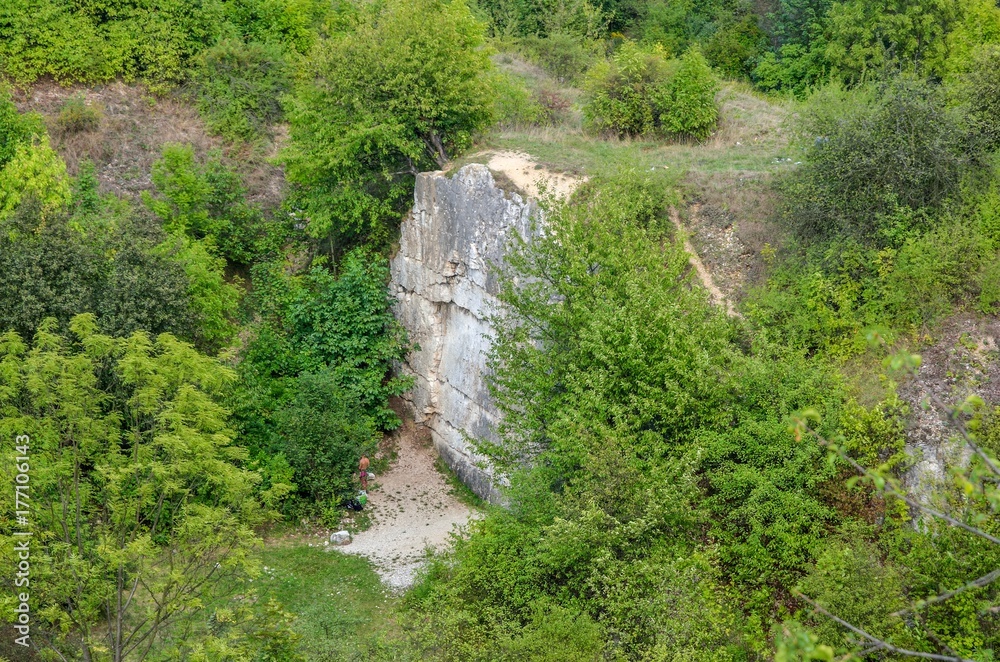 Rocks among green trees. Rocks of Twardowski at the lagoon of Zakrzowek in Krakow, Poland. Rocks among green trees. Rocks of Twardowski at the lagoon of Zakrzowek in Krakow, Poland.