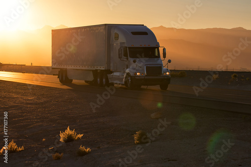 American style truck on freeway pulling load. Transportation theme