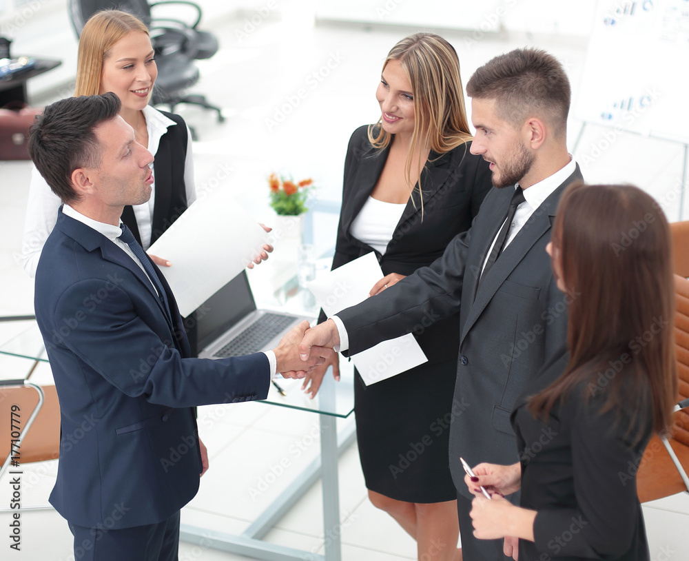 Ταπετσαρία handshake of business partners after signing the contract