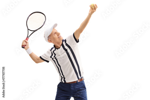 Old tennis player preparing to serve
