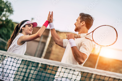 Couple on tennis court © Vasyl