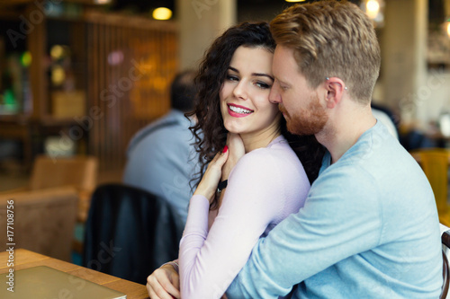 Young happy couple on date in coffee shop