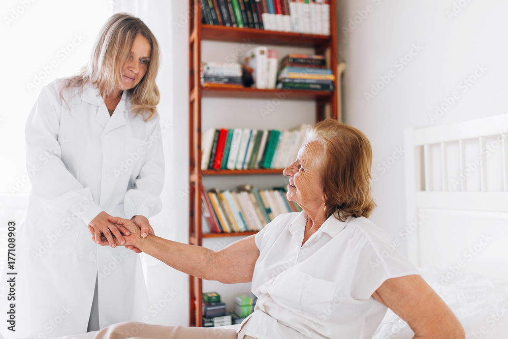 Providing care for elderly. Doctor visiting elderly patient at home. Providing care for elderly. Doctor visiting elderly patient at home.