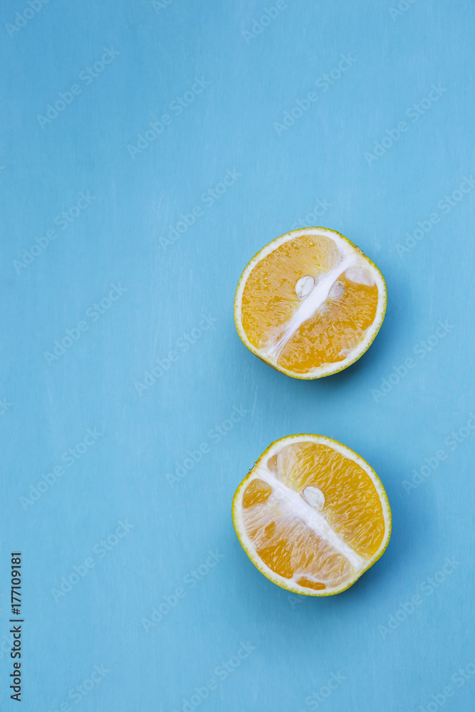 Fresh orange cut with space on wooden blue background Fresh orange cut with space on wooden blue background