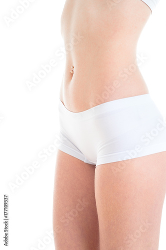 Body part white fitness underwear. Slim tanned woman's body. Isolated over white background.