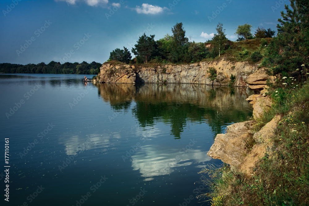 Obraz premium rocky river with pine green trees