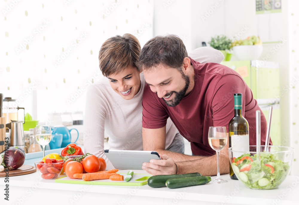 Couple cooking together and using a tablet