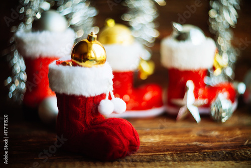 Christmas decoration.Red Santa's boot,fir tree,garland,gift,pine cones and Christmas balls.Christmas background.Soft selective focus.Winter holidays,Merry Christmas or Happy New Year concept.