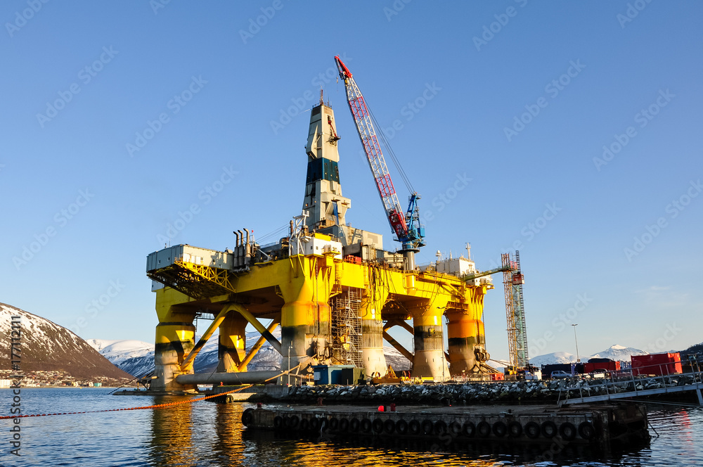Floating oil drilling platform in harbor in Norway